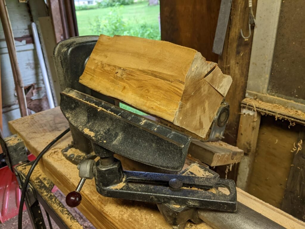 rough pear wood blank on the lathe